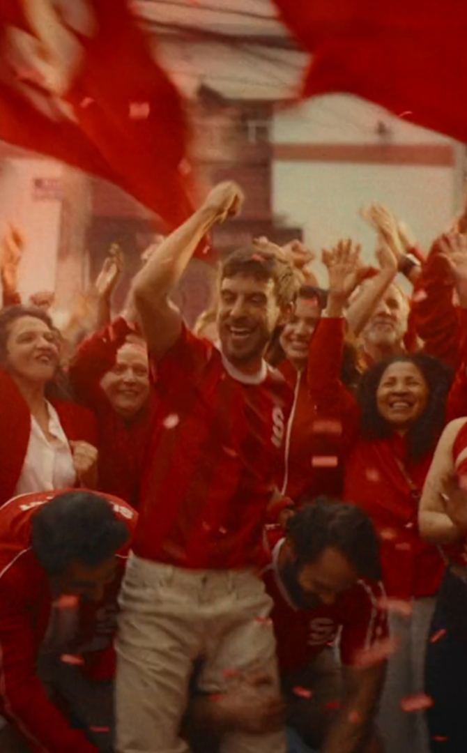 Hinchas celebrando con banderas rojas
